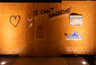 Mapping Prejudice stickers on Hennepin Ave boards.