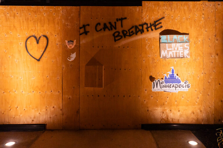 Minneapolis the Happiest Place on Earth sticker 1 Mapping Prejudice stickers on Hennepin Ave boards.