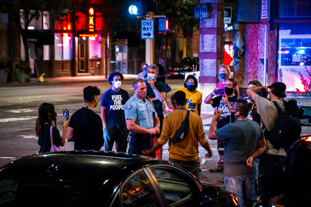 Minneapolis Police 1st precinct Inspector Bill Peterson talks with protesters near the police station following a march that led to arrests.