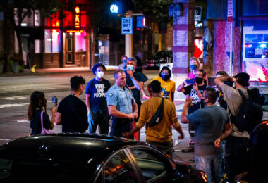 Minneapolis Police 1st precinct Inspector Bill Peterson talks with protesters near the police station following a march that led to arrests.
