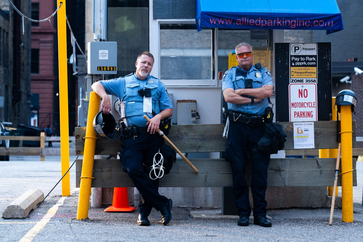 Minneapolis Police officers with zip ties standing near their 1st precinct police station in Downtown Minneapolis.