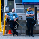 Minneapolis Police officers with zip ties standing near their 1st precinct police station in Downtown Minneapolis.