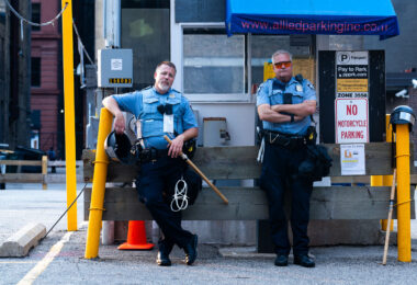 Minneapolis Police officers with zip ties standing near their 1st precinct police station in Downtown Minneapolis.