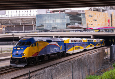 The Northstar Train at the Target Field Station in Minneapolis. Above is Target Field, home of the Minnesota Twins MLB baseball team. COVID-19 warnings scroll on the digital board.