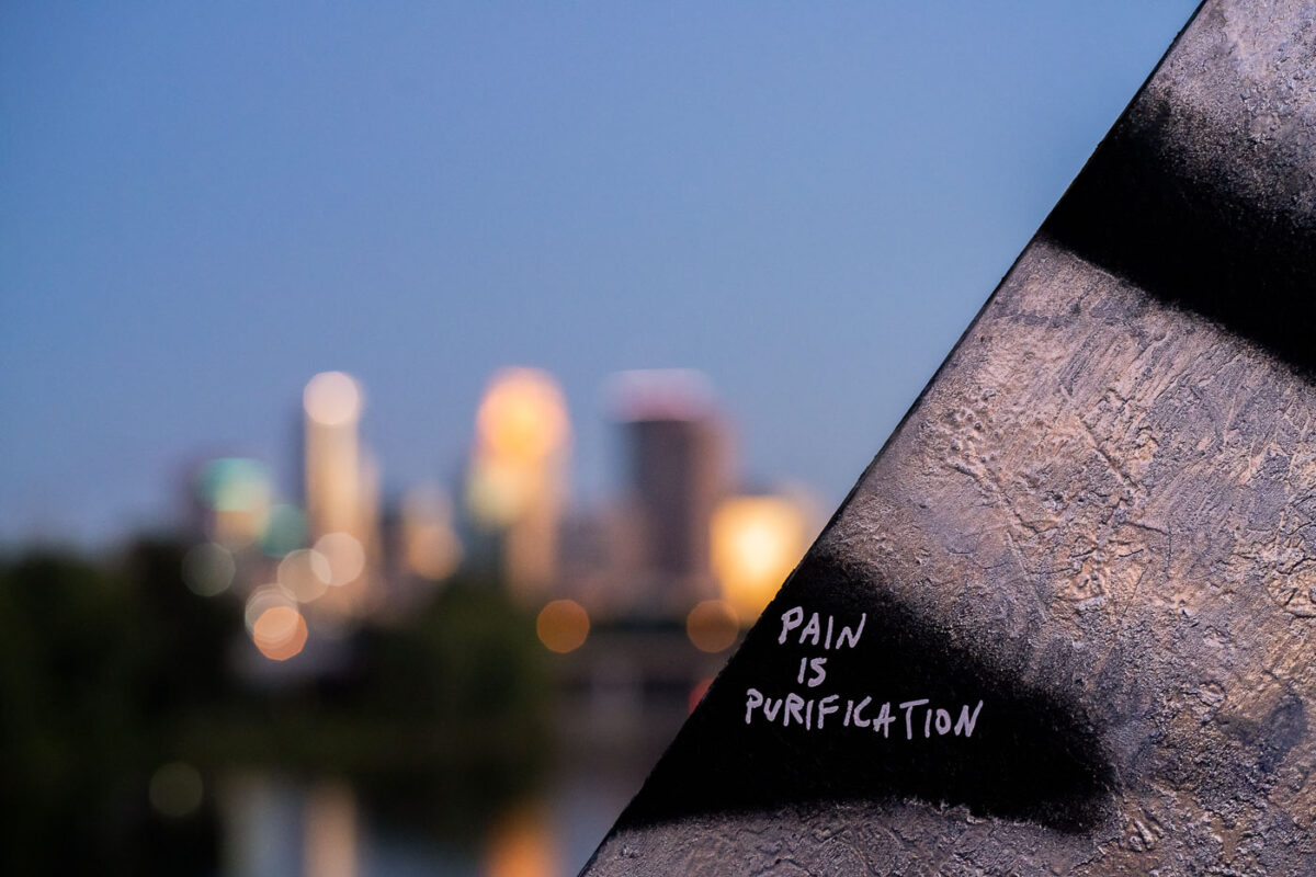 "Pain is Purification" on a train bridge in North Minneapolis.