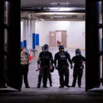 Hennepin County Sheriffs Officers holding cans of irritants inside the garage of the Hennepin County Public Safety Facility, a downtown Minneapolis jail. Protesters were gathering demanding the release of other protesters who were arrested earlier in the evening after a protest through downtown in a Jacob Blake solidarity march.