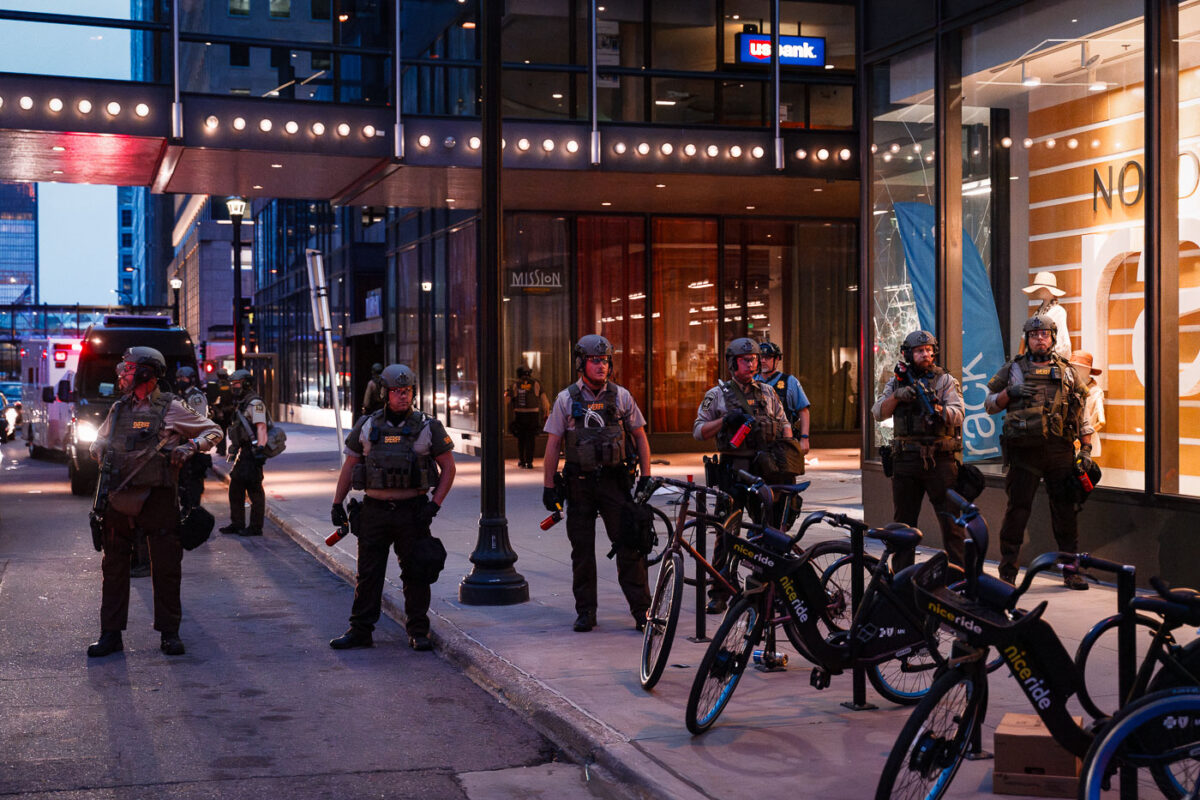 Hennepin County Sheriffs Officers patrol outside the Norstrom Rack and IDS Center in Minneapolis after looting and vandalism on August 27th, 2020.