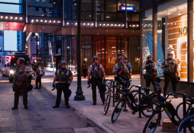 Hennepin County Sheriffs Officers patrol outside the Norstrom Rack and IDS Center in Minneapolis after looting and vandalism on August 27th, 2020.