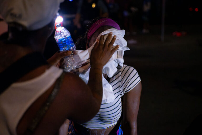 Protester pepper sprayed by Minneapolis Police August 2020 1 A man helps a woman who had been pepper sprayed by the Minneapolis Police following unrest that broke out over false rumors of a police shooting.