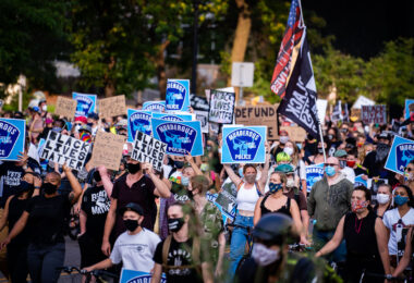 Protesters march through downtown Minneapolis holding signs in solidarity with Jacob Blake after he was shot by Kenosha police.