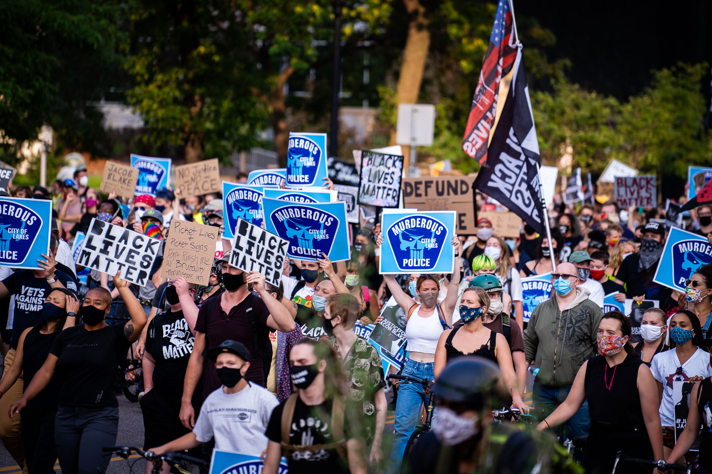 Protesters hold up Murderous Police signs in Minneapolis