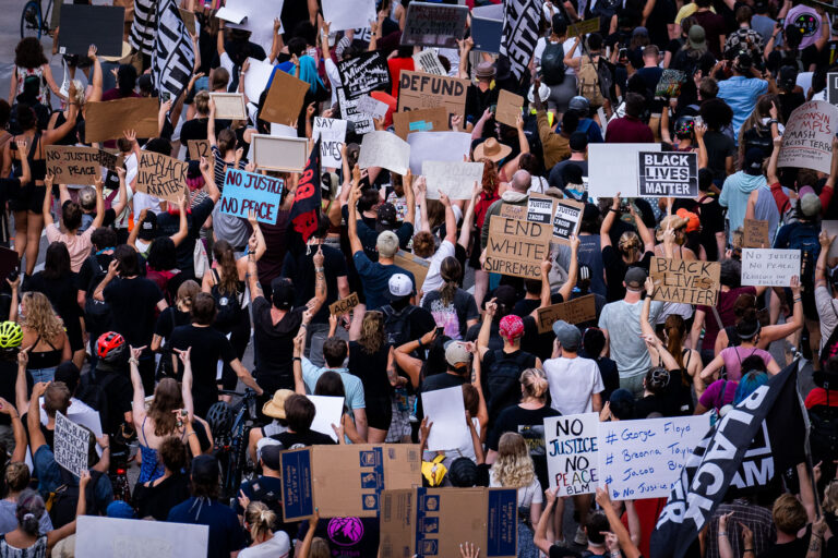 Protesters with signs outside 1st precinct in Downtown Minneapol 2 Protesters outside the Minneapolis Police 1st precinct marching in solidarity demanding justice for Jacob Blake who was shot by Kenosha Police.