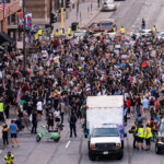 Protesters march in downtown Minneapolis outside the Minneapolis Police 1st precinct police station demanding justice for Jacob Blake who was shot by Kenosha Police.