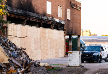 A Minneapolis Police Officer stands guard at the former Wells Fargo Bank in Minneapolis. The building was burned during protests following the May 25th, 2020 death of George Floyd. The security was 24/7 while the bank looked for a way to safely allow people into the building to retrieve the items in their safety deposit boxes.
