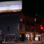Twitter billboard in downtown Minneapolis displaying a tweet reading "Protesters aren't trying to start a race war - we're trying to end one.".
