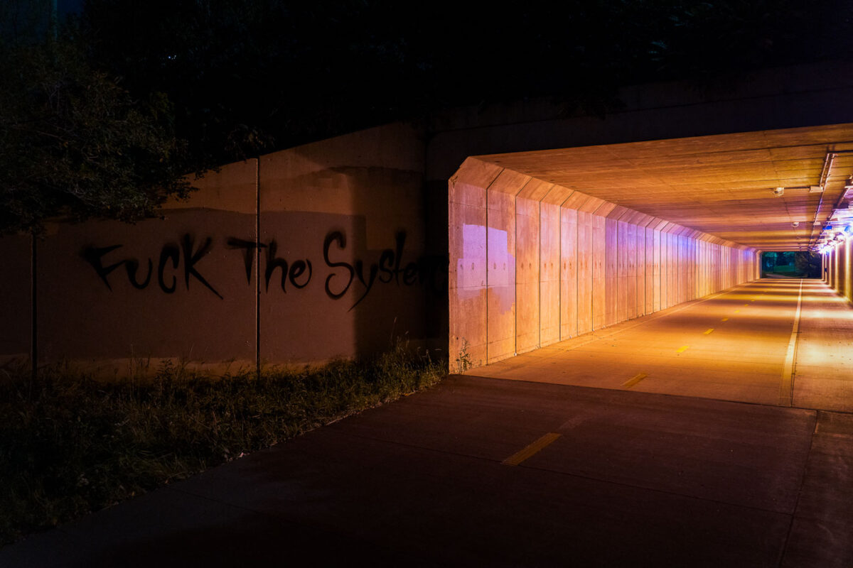 "Fuck The System" written on a bike trail near downtown Minneapolis.