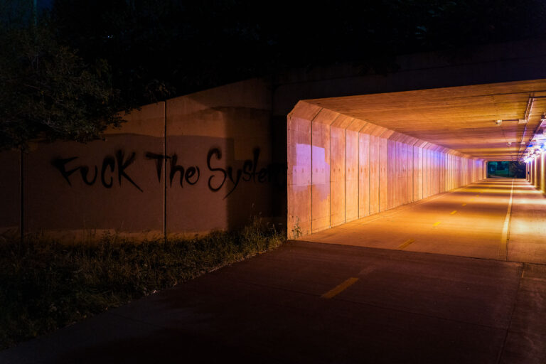 "Fuck The System" Graffiti, Minneapolis Bike Trail Tunnel 3 “Fuck The System” graffiti beside a lit bike trail tunnel in Minneapolis, September 2020.