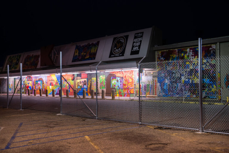 K-Mart on Lake Street with boards and murals 1 Fencing in the parking lot of the former K-Mart as the United States Postal Service prepares to move in.