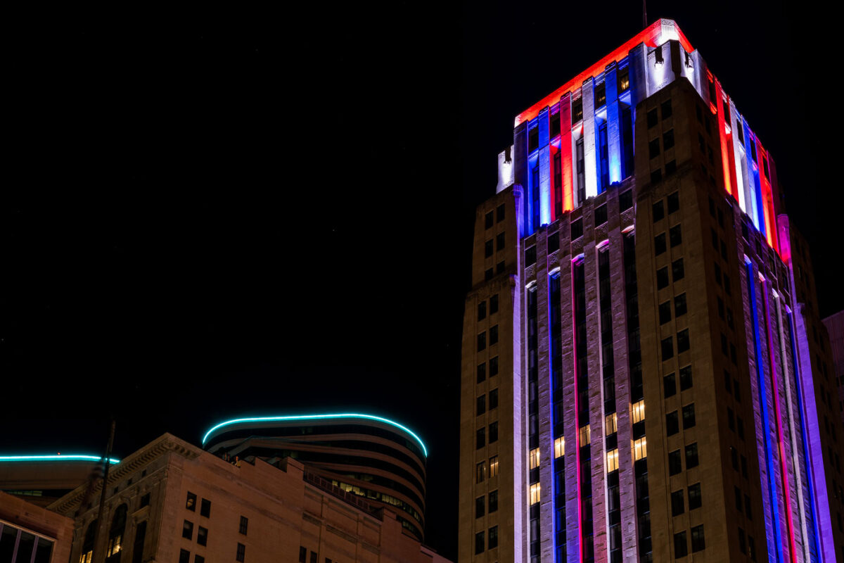 The Rand Tower lit up in blue red and white.