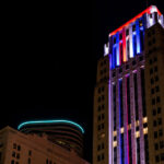The Rand Tower lit up in blue red and white.