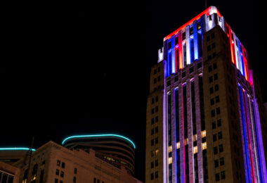 The Rand Tower lit up in blue red and white.