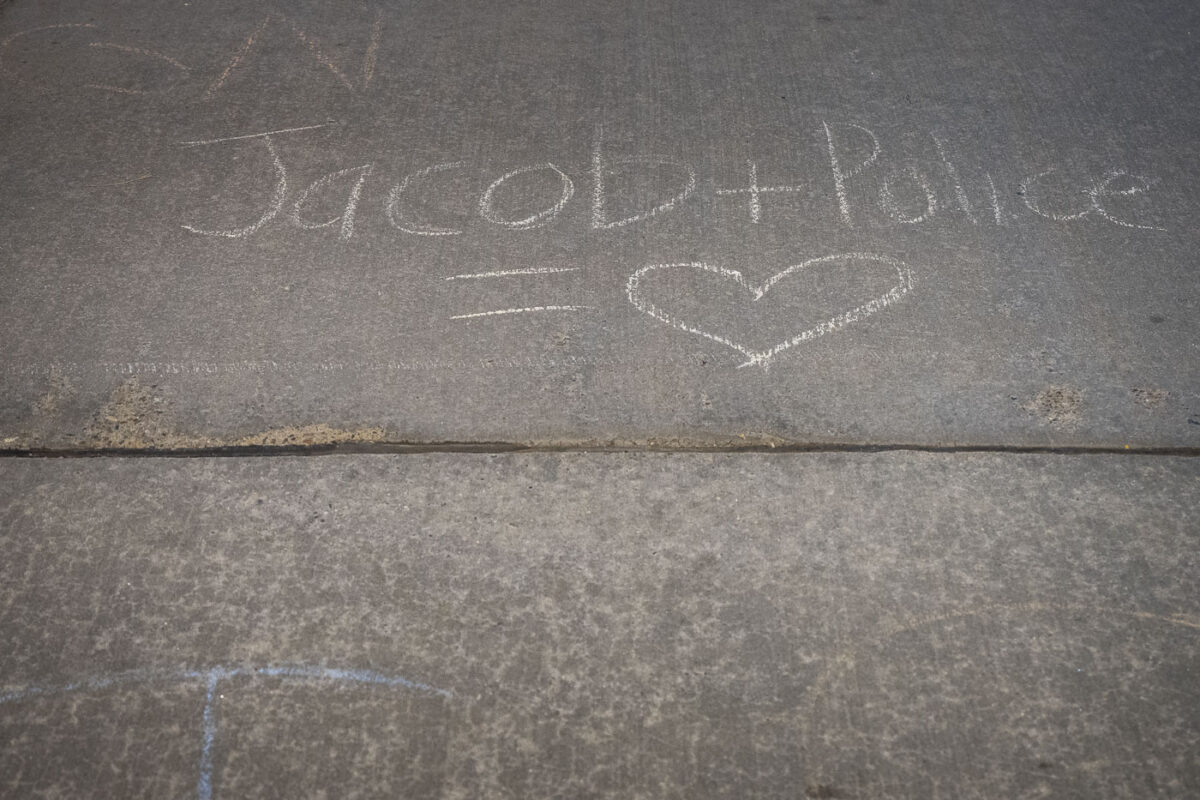 Chalk on the street outside Minneapolis Mayor Jacob Frey's home. Protesters gathered to protest homeless encampment evictions.