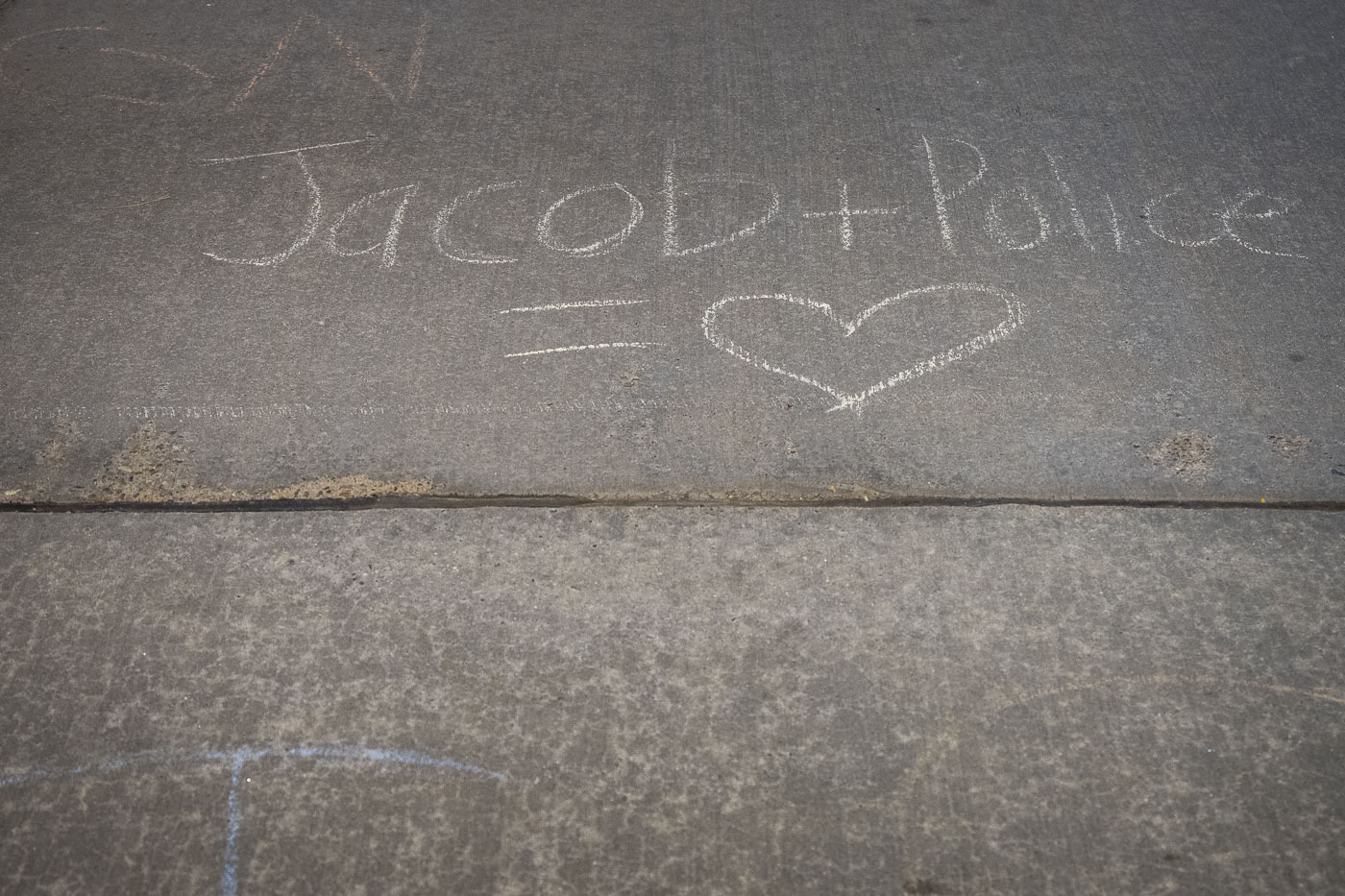 Chalk on the sidewalk outside the mayors home