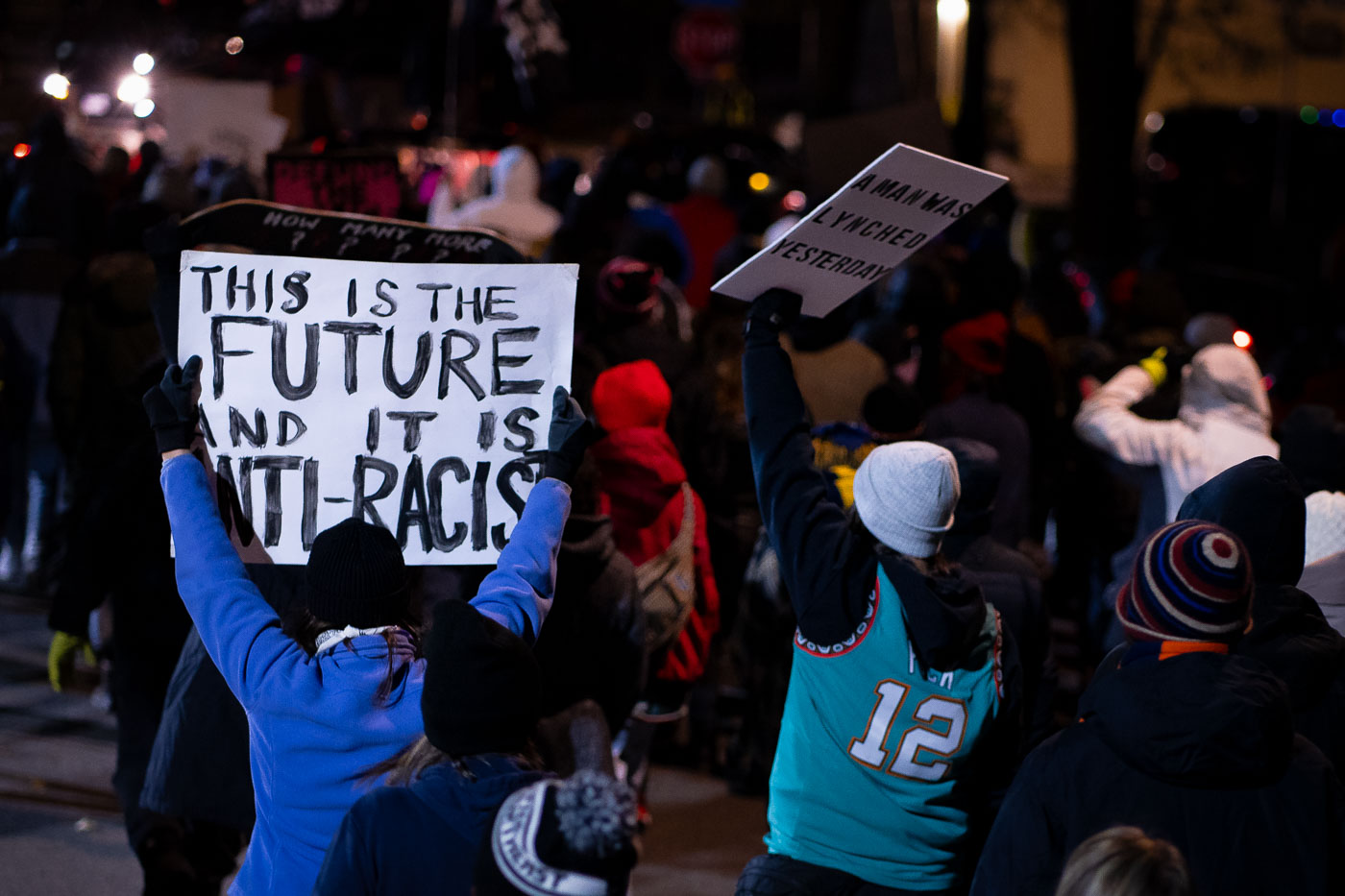 Protesters hold signs up after the killing of Walter Wallace