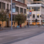 Bikers bike past boarded up buildings on Nicollet Mall in Downtown Minneapolis.
