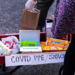 A protester with a wagon full of PPE for other protesters during a march shortly after Biden was announced the winner of the 2020 Presidential Election.