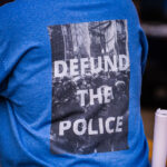 Protester wearing a "Defund the police" shirt in Minneapolis during a protest following the announcing of Joe Biden winner of the Presidential election against Donald Trump.