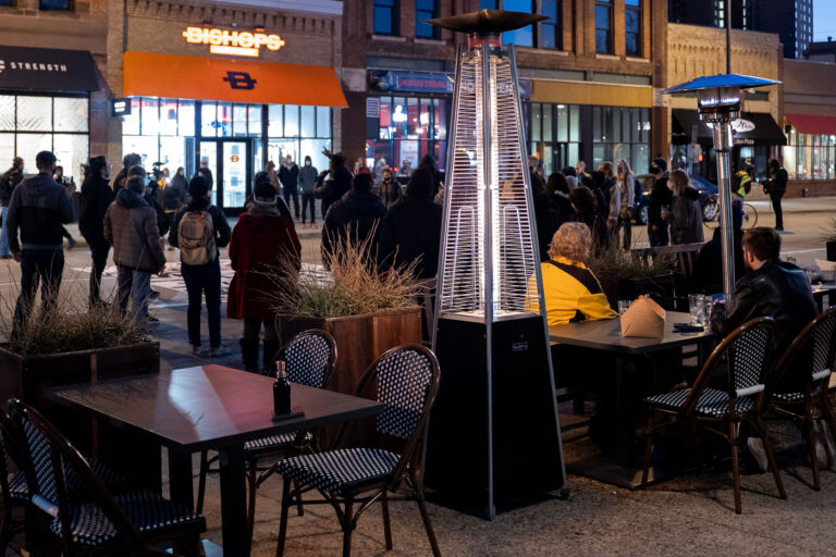 Couple eat dinner across from protest 1 Protesters outside Minneapolis Mayor Jacob Frey’s home in Northeast Minneapolis. The protesters are demanding the mayor do something about housing issues in the city with homelessness at record levels. A couple eating dinner on a patio across the street.