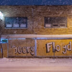 Storefront boards reading "George Floyd" on Lake Street during snowfall.