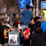 Protester with a large Hitler/Trump patch on her back following a march through Minneapolis after Biden was announced winner of the Presidential election.