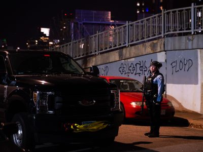 Police Officer Near "FLOYD" Graffiti Along I-94 in Minneapolis