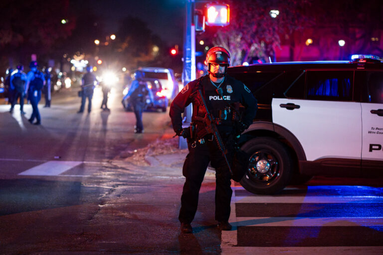 Armed Minneapolis Police officer during protest 3 Minneapolis Police officer stands in the street near Bryant Square Park where arrests were made following an election night march through Uptown.