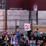Protesters gather outside of the Minneapolis Police Third Precinct as part of a march shortly after Biden was announced as winner of the Presidential election.