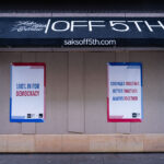 Signs on the side of Saks Off 5th Avenue in Downtown Minneapolis.