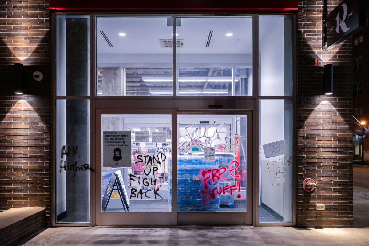 Graffiti on the windows of a Target Store in Uptown Minneapolis that reads “Stand Up Fight Back” “Free Stuff”. The graffiti appeared following a march down Lake Street on election night.