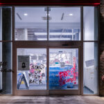 Graffiti on the windows of a Target Store in Uptown Minneapolis that reads “Stand Up Fight Back” “Free Stuff”. The graffiti appeared following a march down Lake Street on election night.