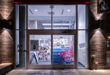 Graffiti on the windows of a Target Store in Uptown Minneapolis that reads “Stand Up Fight Back” “Free Stuff”. The graffiti appeared following a march down Lake Street on election night.