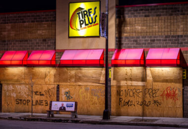 Graffiti on Tires Plus boards that read “Stop Line 3” “No More Prez” “Riots 2020”