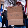 A protester holds up a sign that reads “Stop The Steal” outside the Minnesota Governor’s mansion in St. Paul, Minnesota on November 14, 2020.