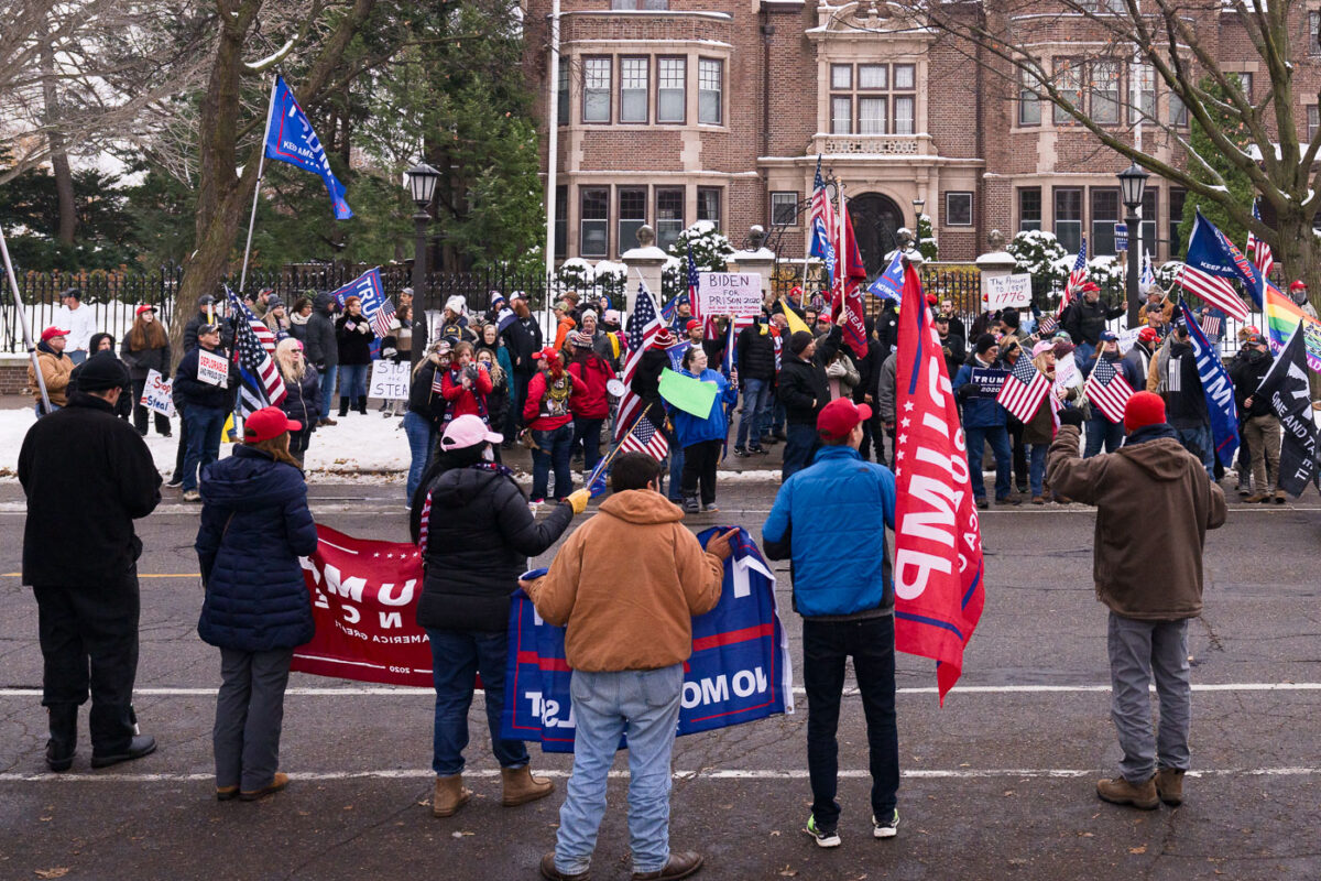 "Stop the Steal" rally at the Minnesota Governor's Mansion. Man holding up a sign that reads "Biden For President 2020 We Don't Need a Pedophile Communist Traitor President".