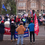Governor's Mansion Protest 4 "Stop the Steal" rally at the Minnesota Governor's Mansion. Man holding up a sign that reads "Biden For President 2020 We Don't Need a Pedophile Communist Traitor President".