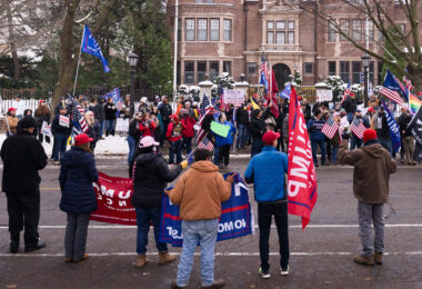 "Stop the Steal" rally at the Minnesota Governor's Mansion. Man holding up a sign that reads "Biden For President 2020 We Don't Need a Pedophile Communist Traitor President".