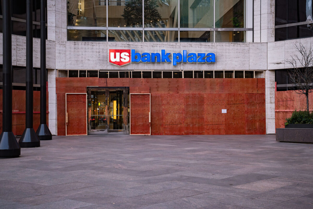 US Bank Plaza in downtown Minneapolis with boards covering the windows.