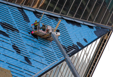 Construction workers work to repair the side of US Bank Stadium in November 2020.