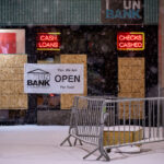 “Yes, we are open for you” banner on a boarded cup UnBank branch in Downtown Minneapolis.