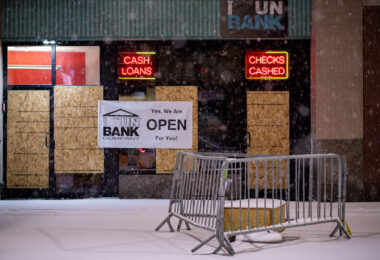 “Yes, we are open for you” banner on a boarded cup UnBank branch in Downtown Minneapolis.